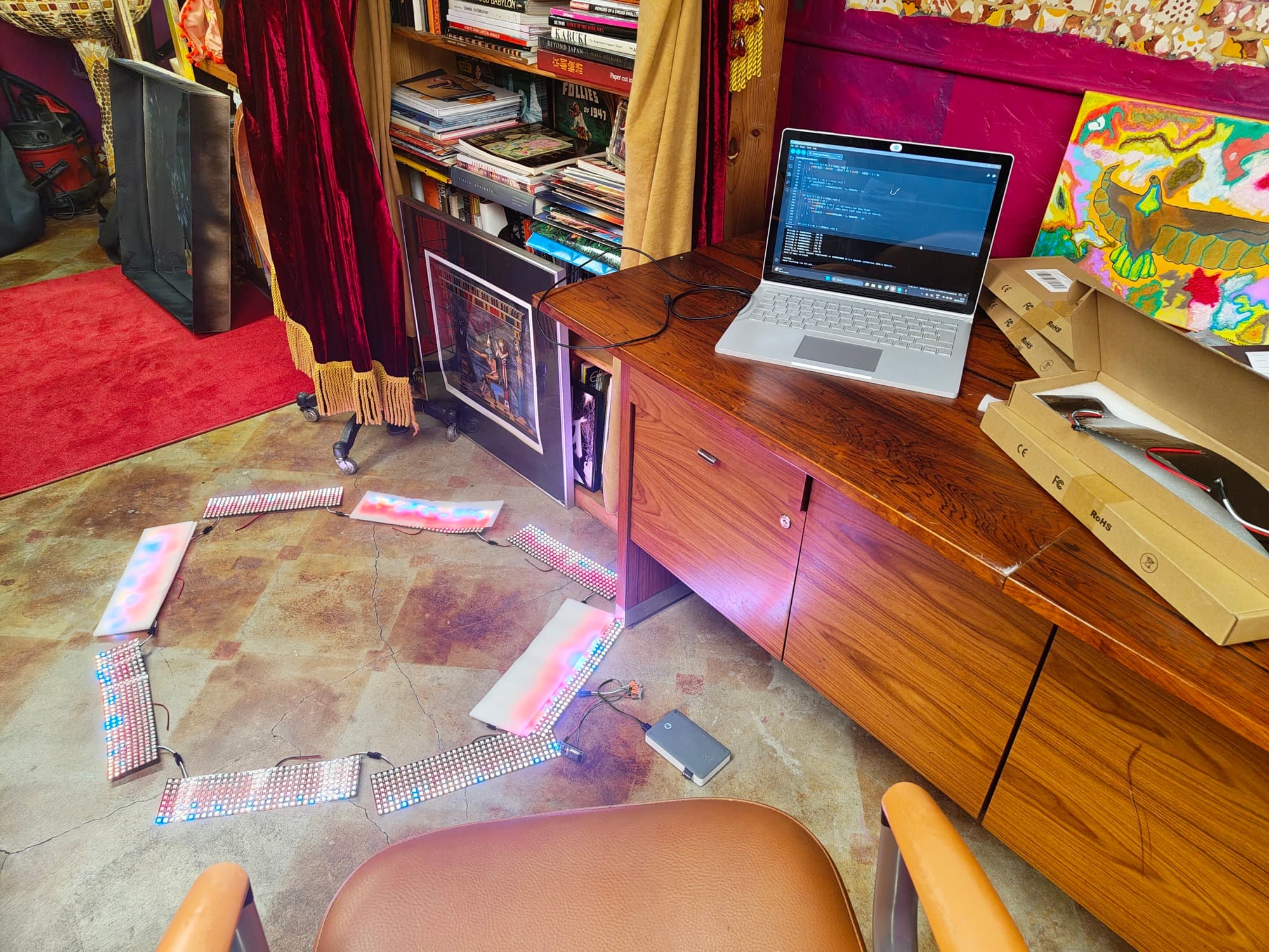 LED matrix panels chained across the studio floor, running a test pattern