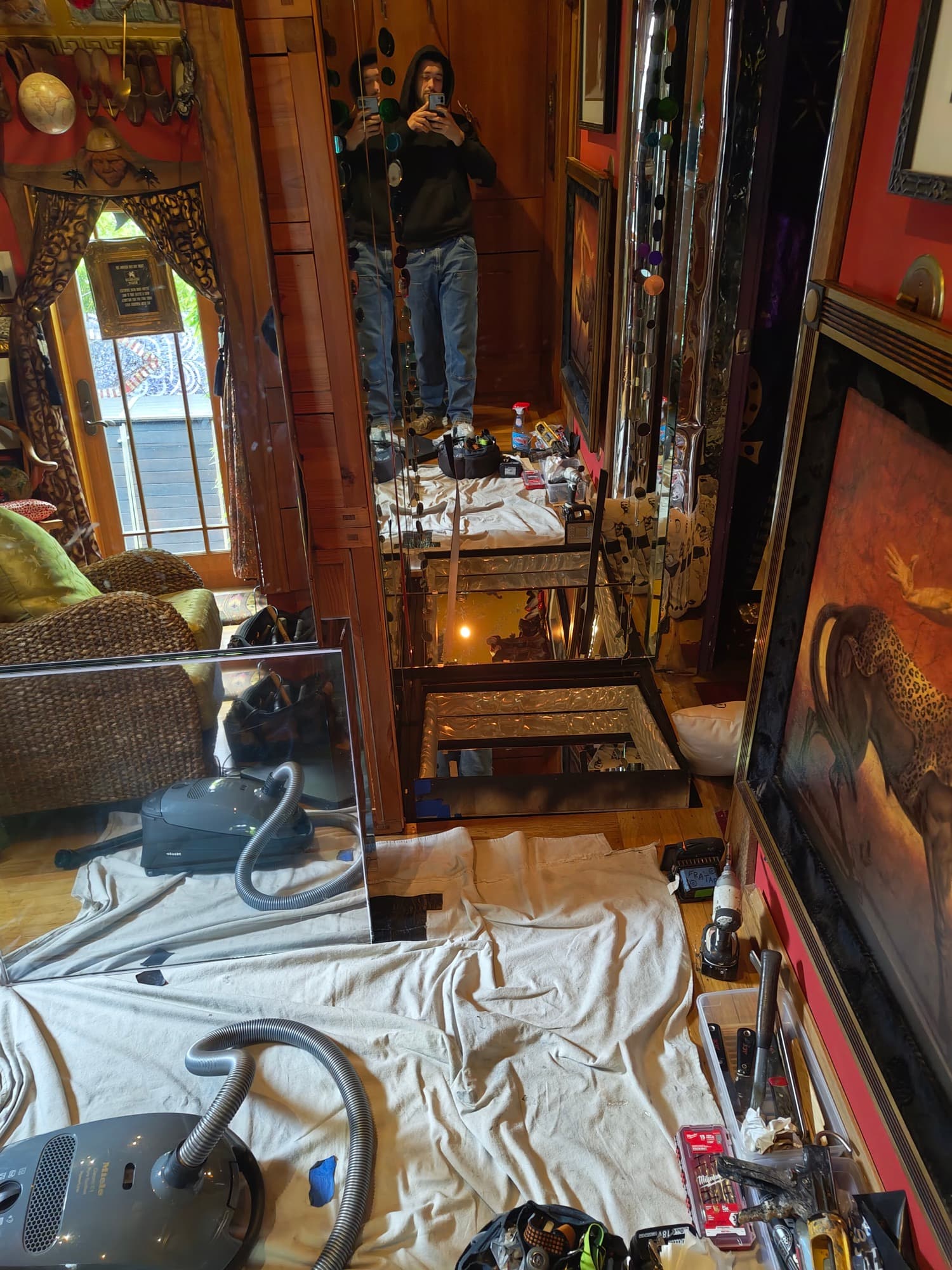 Mirror panels assembled around the floor opening